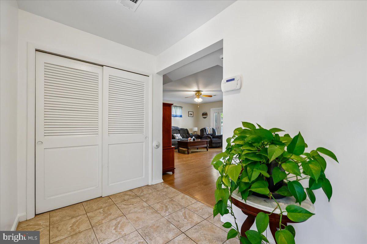 5001 Aspen Hill Road Rockville, MD 20853 - Photo 6 of 68 a hallway with a dining table and a potted plant