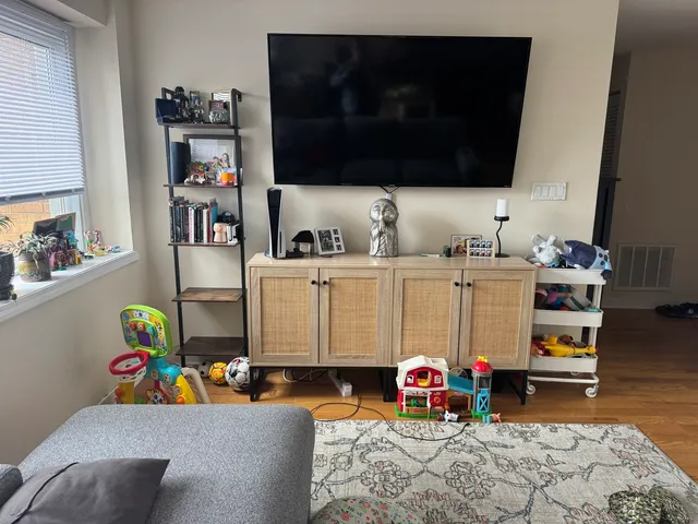 a bedroom with furniture and a flat screen tv