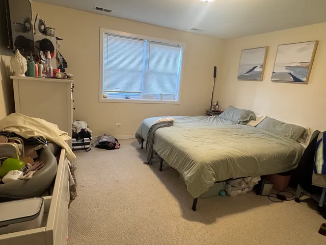 a bedroom with a bed and cabinets