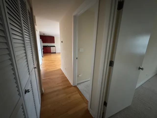 a view of a hallway with the wooden shelves