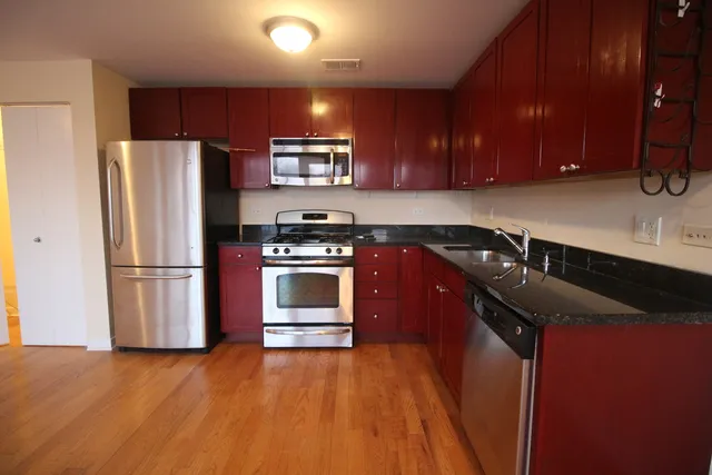a kitchen with a sink a refrigerator and a stove