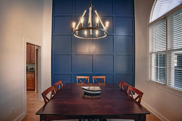 a view of a dining room with furniture wooden floor and chandelier