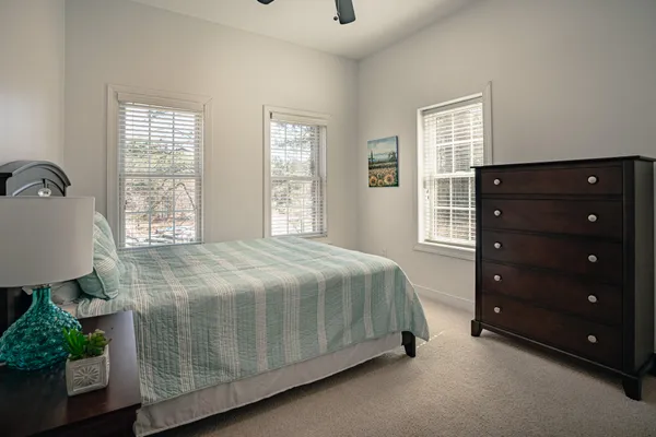 a bedroom with a large bed and a window