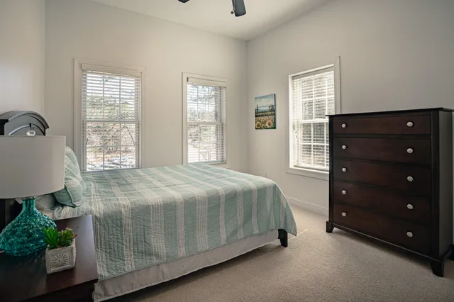 a bedroom with a large bed and a window