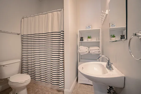 an aerial view of a house with a yard and lake view