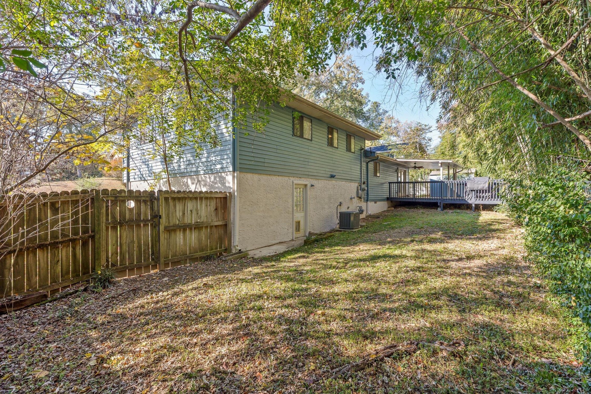 1313 Michael Lane Hixson, TN 37343 - Photo 22 of 24 a view of a backyard with a large tree and wooden fence