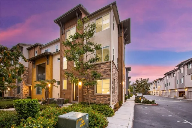 a couple of cars parked in front of a building