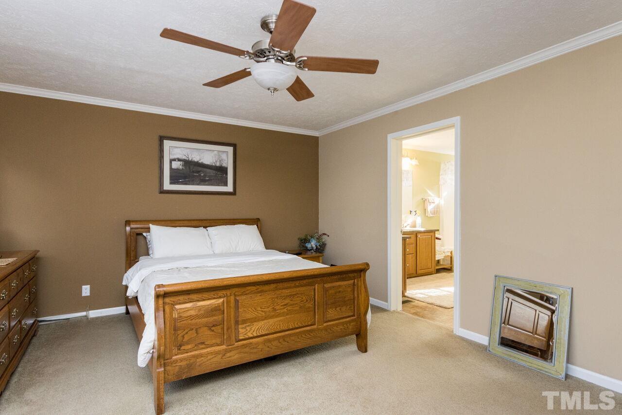 175 Williams Road Spring Hope, NC 27882 - Photo 14 of 30 a bedroom with a bed and a ceiling fan