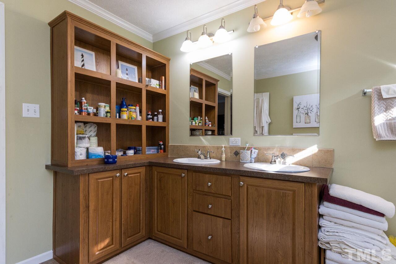 175 Williams Road Spring Hope, NC 27882 - Photo 15 of 30 a view of cabinets a sink and a mirror