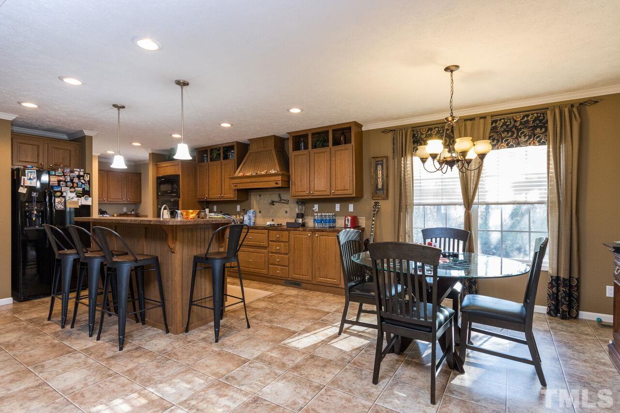 175 Williams Road Spring Hope, NC 27882 - Photo 6 of 30 a dining area with a table chairs and a kitchen view