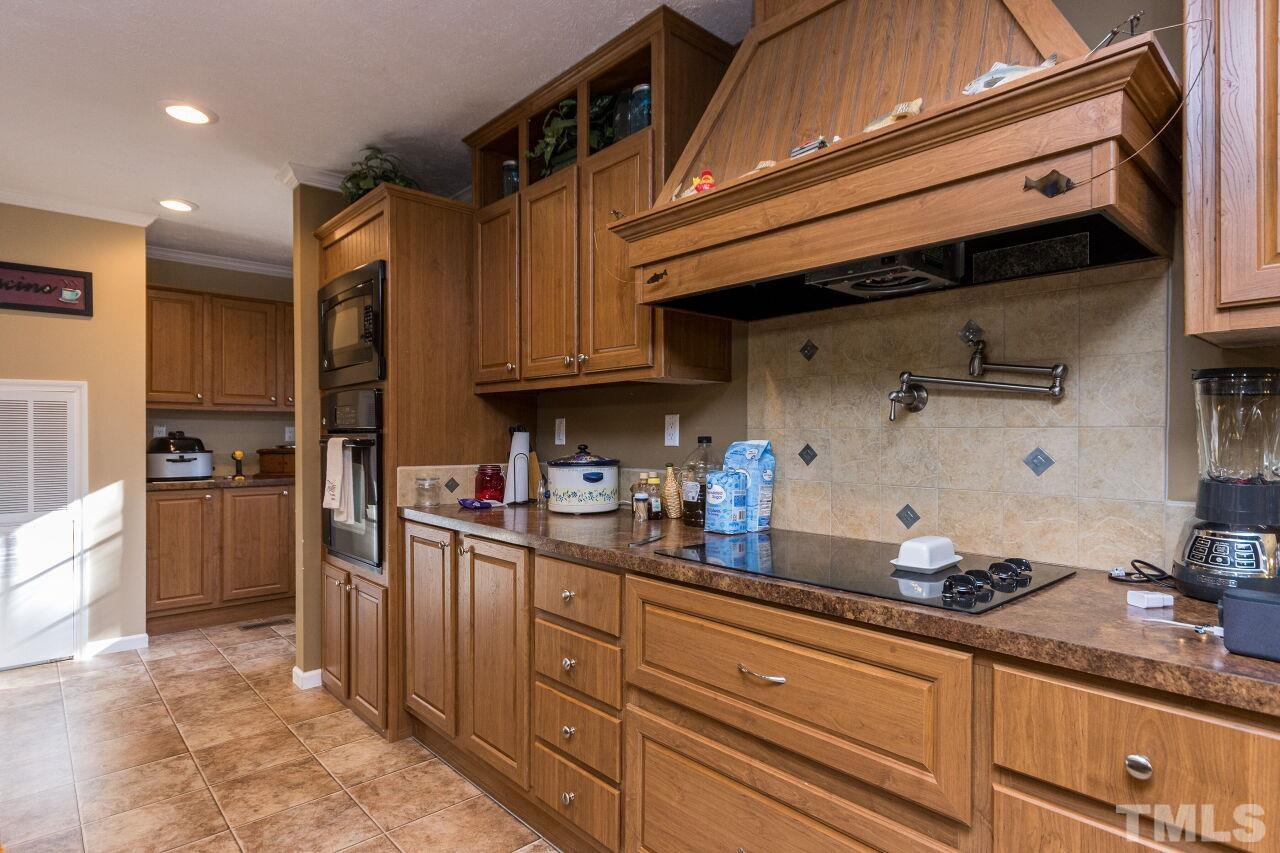 175 Williams Road Spring Hope, NC 27882 - Photo 10 of 30 a kitchen with granite countertop a sink stainless steel appliances and cabinets