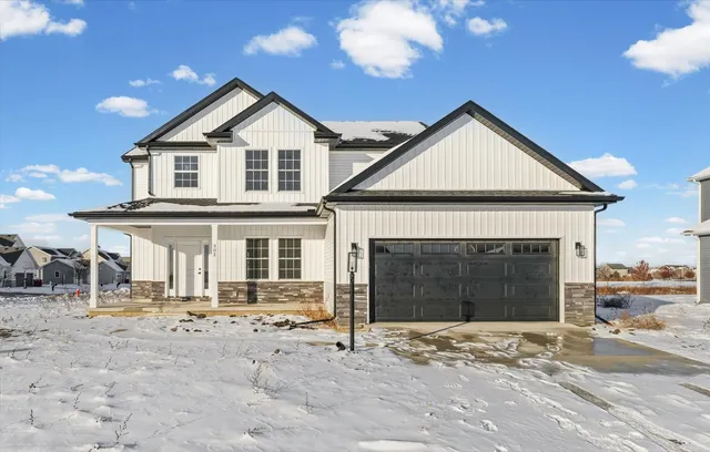a view of a house with a yard and garage
