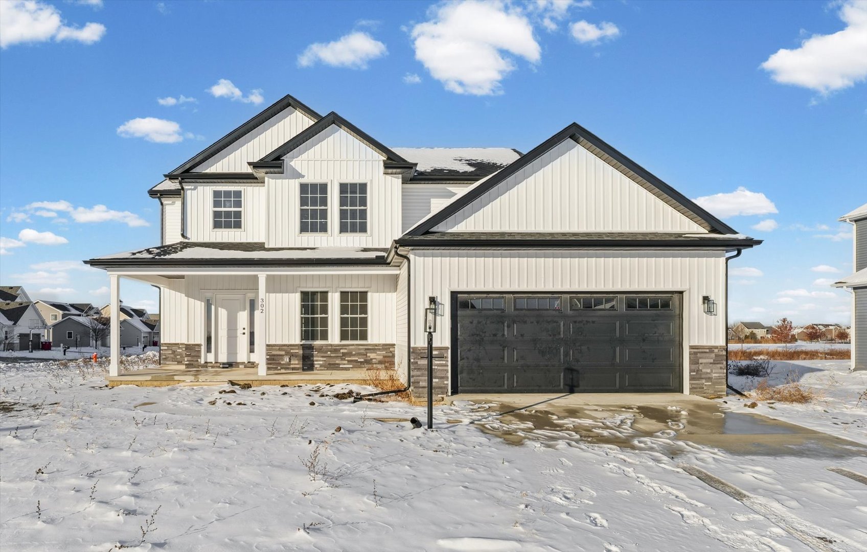 a view of a house with a yard and garage
