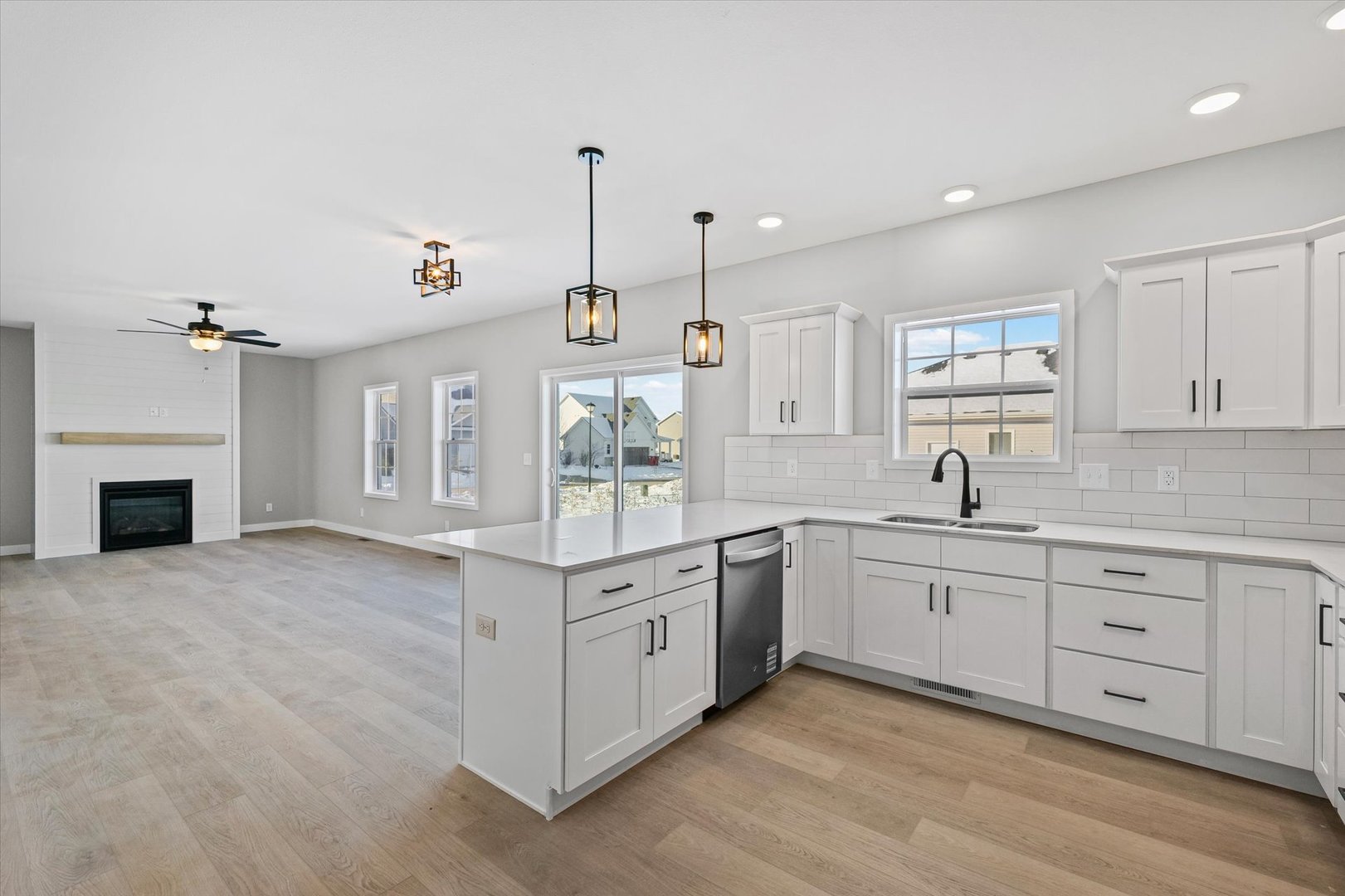 302 Sutton Street Savoy, IL 61874 - Photo 12 of 32 a large white kitchen with cabinets and wooden floor