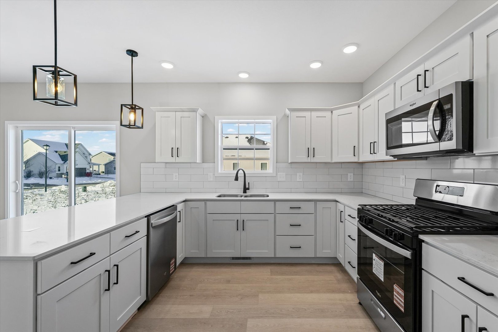 302 Sutton Street Savoy, IL 61874 - Photo 13 of 32 a kitchen with stainless steel appliances granite countertop a sink stove and microwave