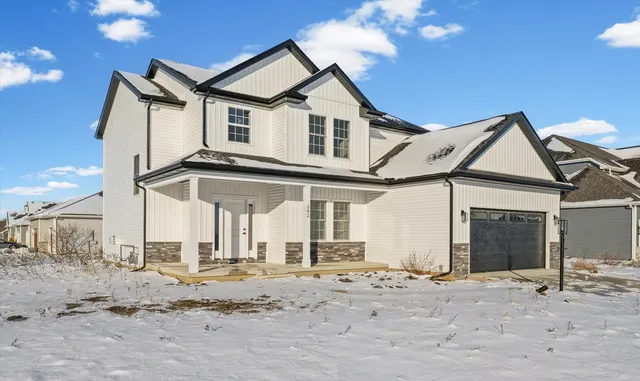 a view of a very nice looking house with a snow on the road