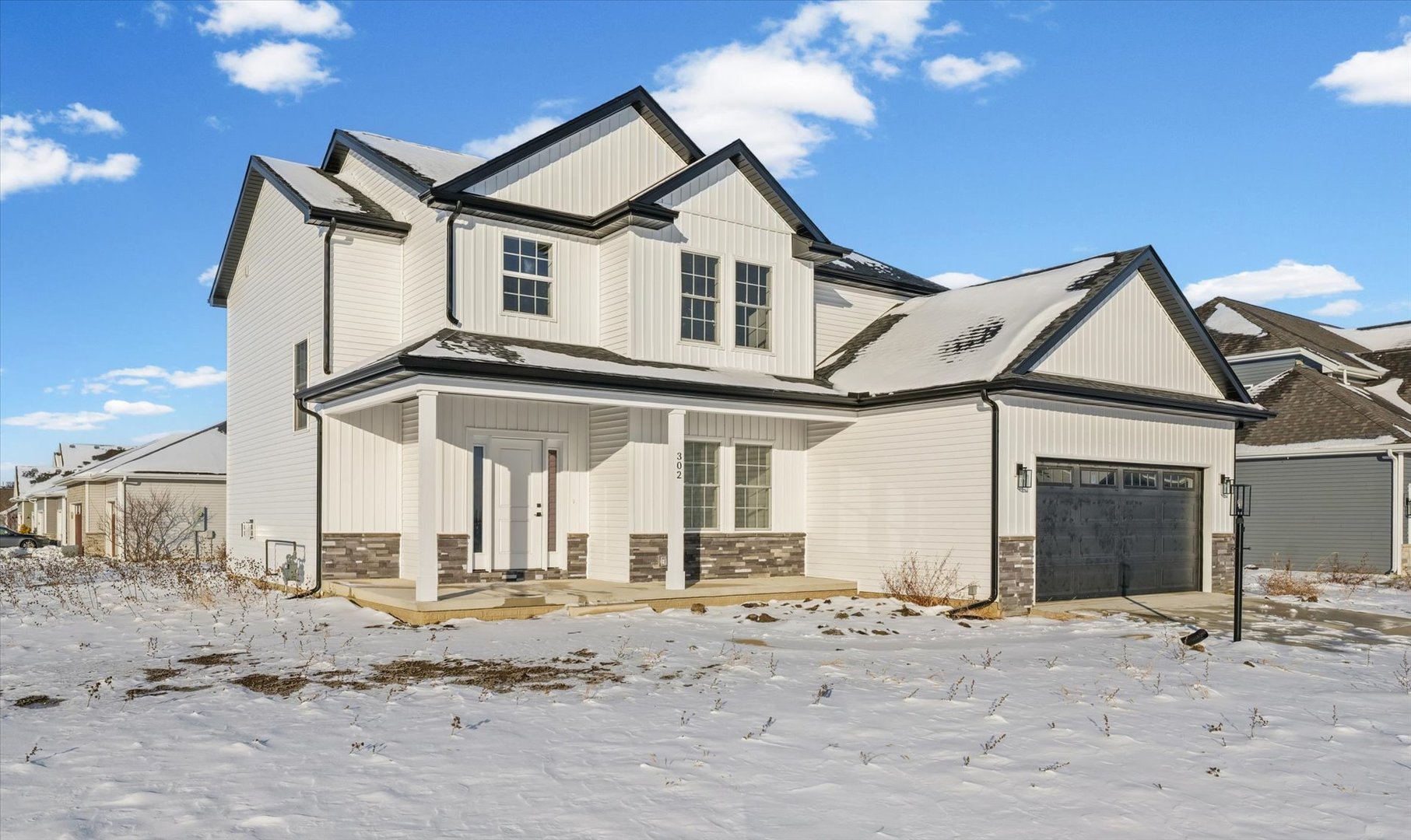 302 Sutton Street Savoy, IL 61874 - Photo 2 of 32 a view of a very nice looking house with a snow on the road