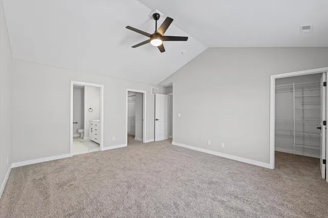 a view of a livingroom with a ceiling fan and entryway