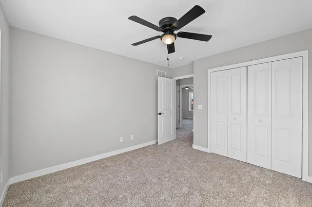 an empty room with a ceiling fan and a ceiling fan
