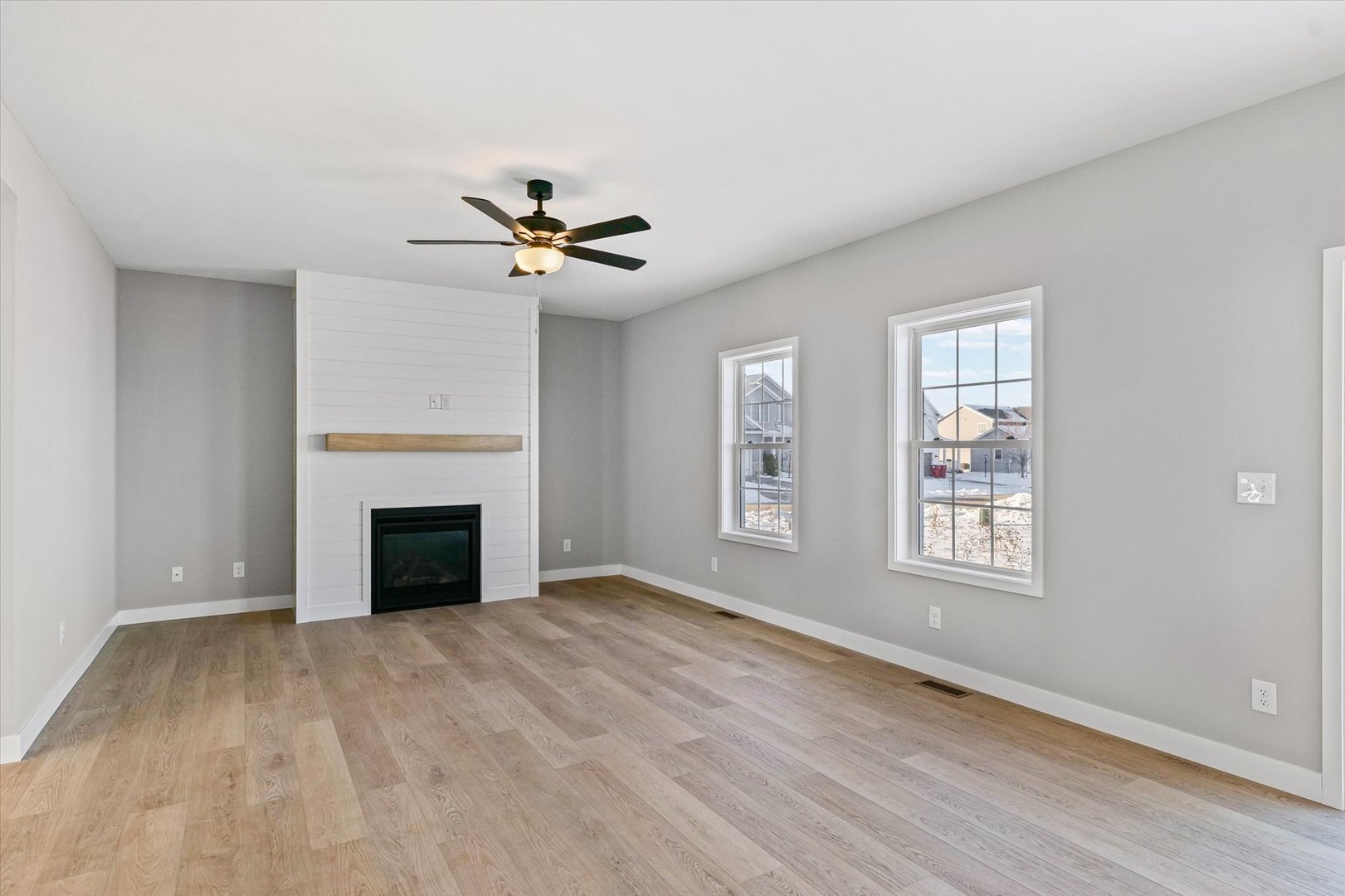 302 Sutton Street Savoy, IL 61874 - Photo 6 of 32 a view of an empty room with a fireplace and a window