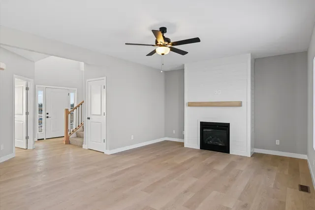 an empty room with closet and a fireplace