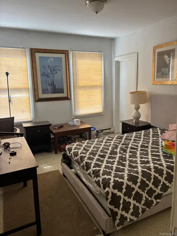 a bedroom with bed and a window