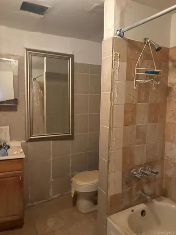 a bathroom with a shower a toilet and sink