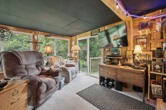 a dining room with furniture water view and a floor to ceiling window