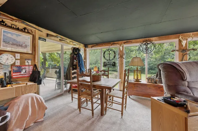 a dining room with furniture window and wooden floor