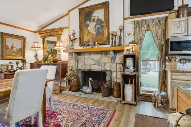 a view of a patio with table and chairs and floor to ceiling window with wooden floor