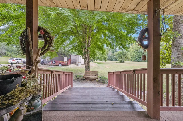 a view of a house with a patio and a yard