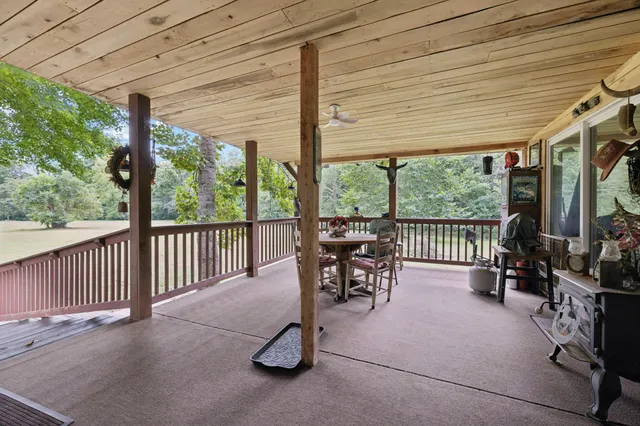 a view of a house with backyard porch and sitting area