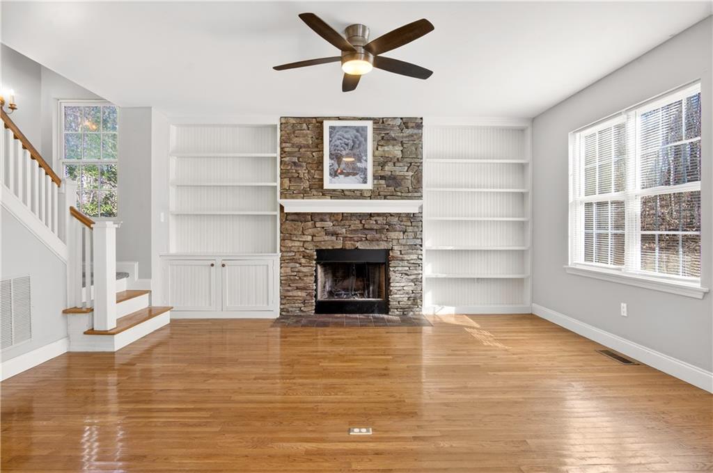3016 Pathway Road Gainesville, GA 30501 - Photo 13 of 44 a view of a livingroom with a fireplace a ceiling fan and windows