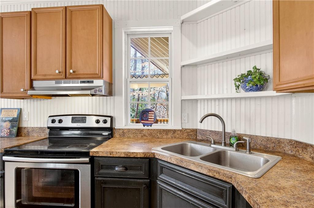 3016 Pathway Road Gainesville, GA 30501 - Photo 18 of 44 a kitchen with granite countertop a stove and a sink