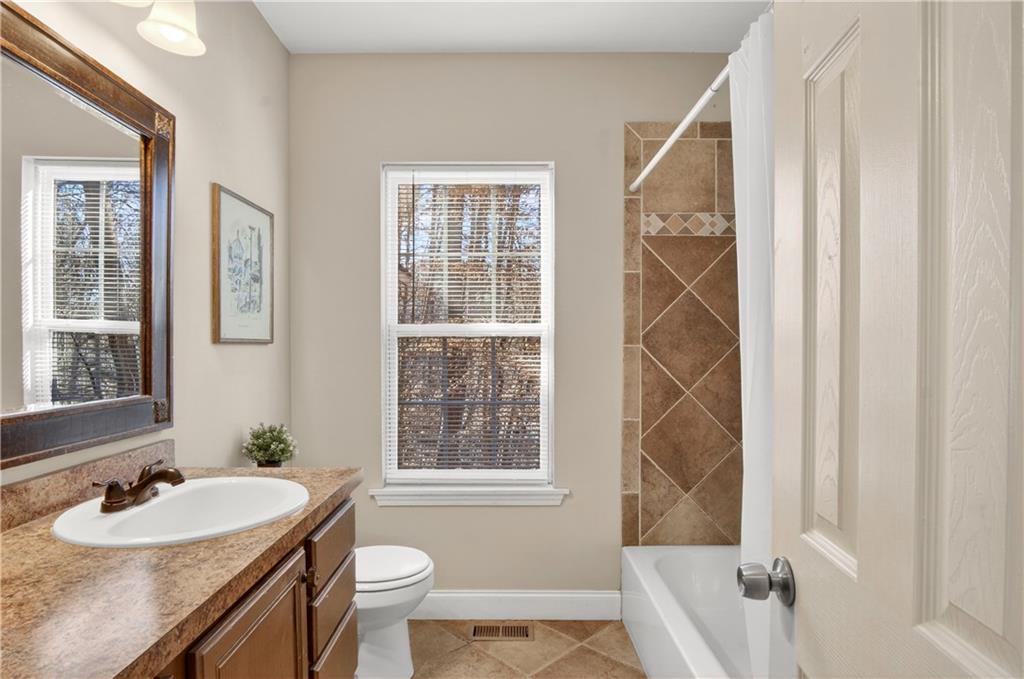 3016 Pathway Road Gainesville, GA 30501 - Photo 23 of 44 a bathroom with a sink and a mirror
