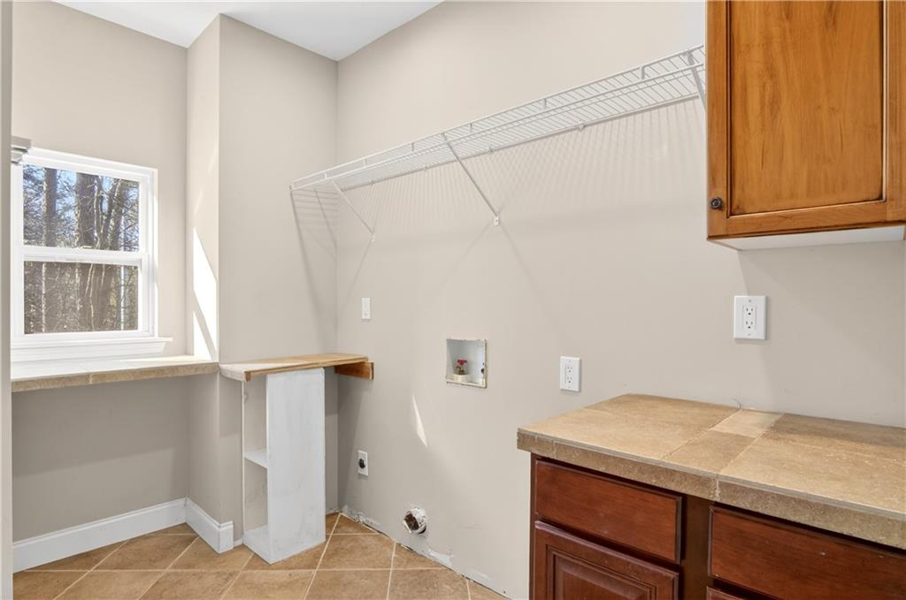 3016 Pathway Road Gainesville, GA 30501 - Photo 25 of 44 a room with a window and wooden cabinets