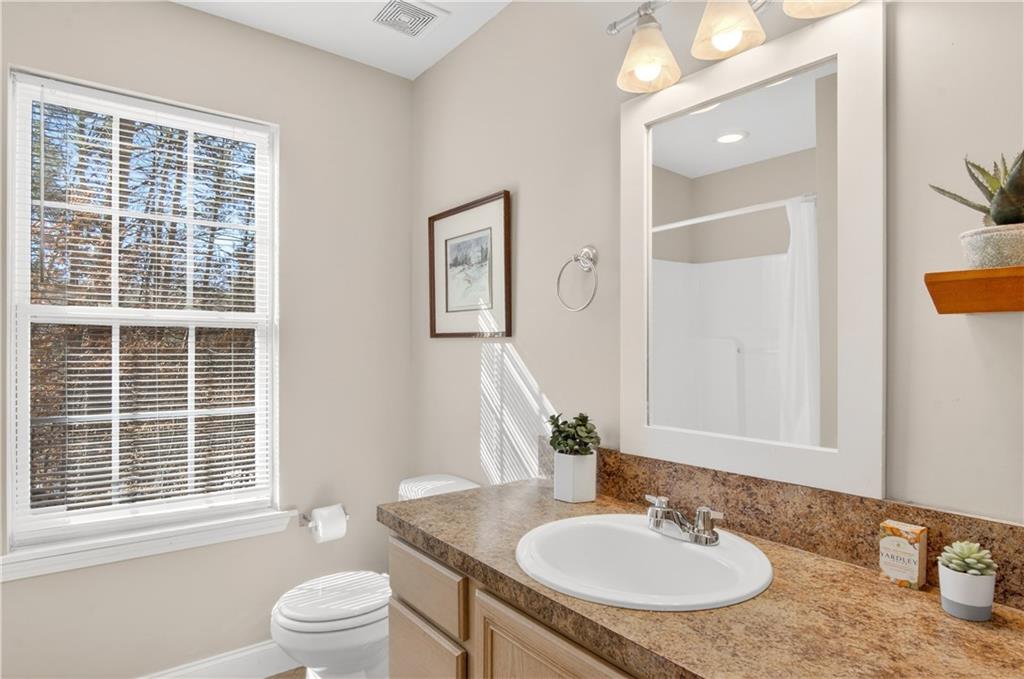 3016 Pathway Road Gainesville, GA 30501 - Photo 28 of 44 a bathroom with a granite countertop sink and a mirror