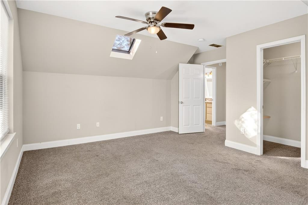3016 Pathway Road Gainesville, GA 30501 - Photo 30 of 44 an empty room with chandelier fan and windows
