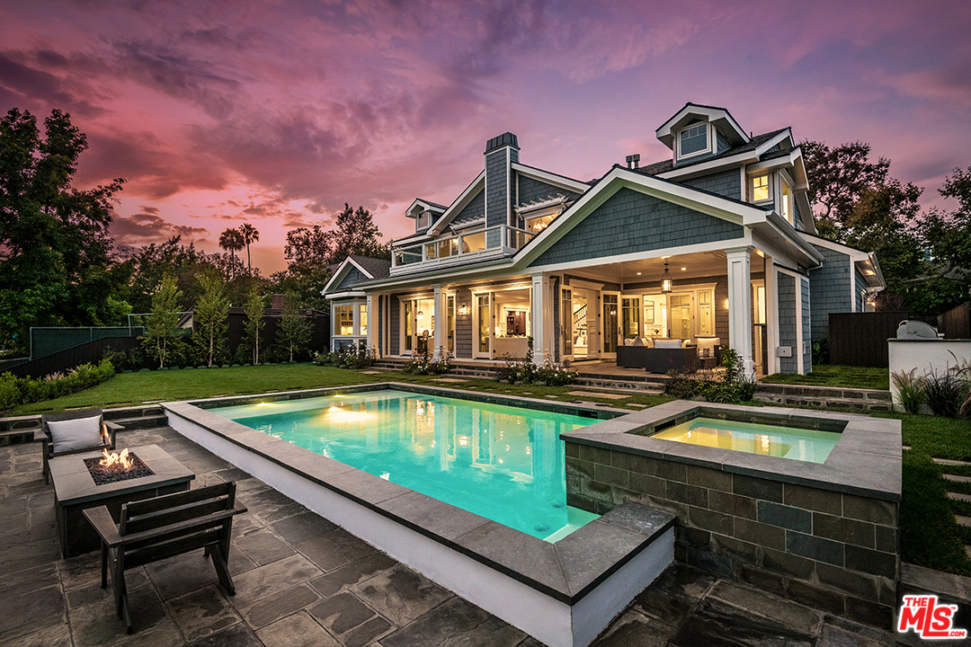 a view of a house with pool and chairs