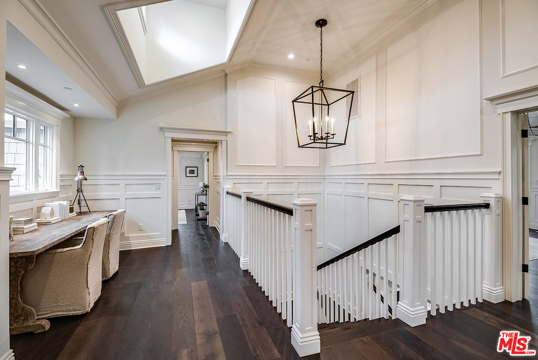 231 South Valley Street Burbank, CA 91505 - Photo 23 of 43 a kitchen with stainless steel appliances granite countertop a dishwasher a stove a dining table and chairs with wooden floor