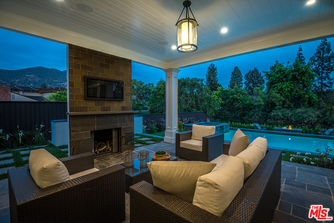 231 South Valley Street Burbank, CA 91505 - Photo 5 of 43 a living room with furniture a fireplace and a floor to ceiling window