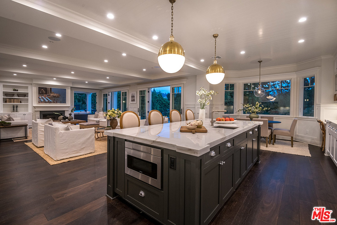 231 South Valley Street Burbank, CA 91505 - Photo 9 of 43 a large kitchen with kitchen island a stove a table a sink a dining table and chairs