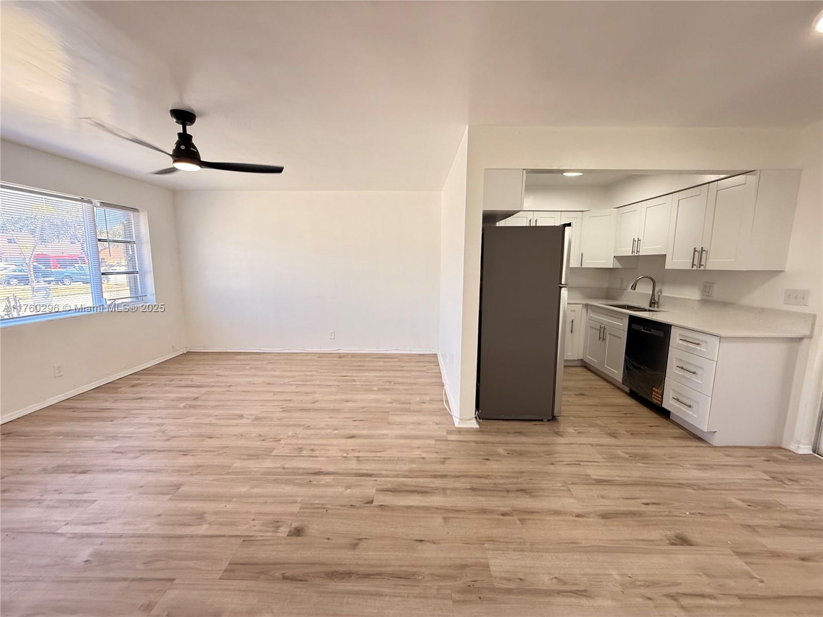 a view of a kitchen with a stove cabinets and wooden floor