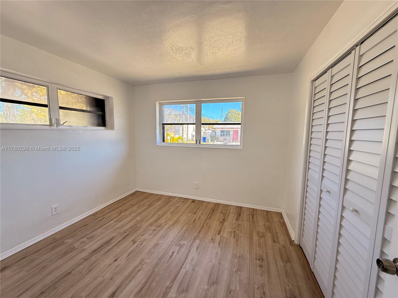 801 Southwest 7th Street, Unit B Pompano Beach, FL 33060 - Photo 11 of 20 wooden floor in an empty room with a window