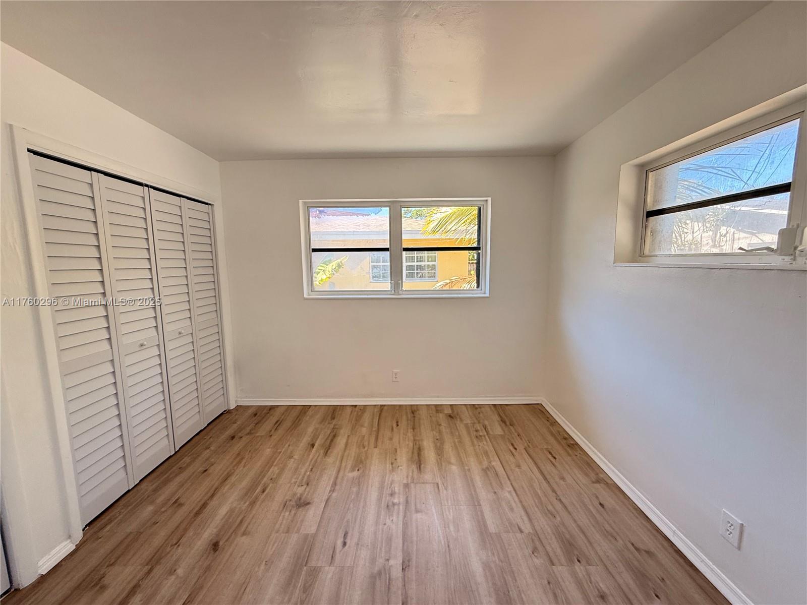 801 Southwest 7th Street, Unit B Pompano Beach, FL 33060 - Photo 15 of 20 a view of empty room with wooden floor and fan