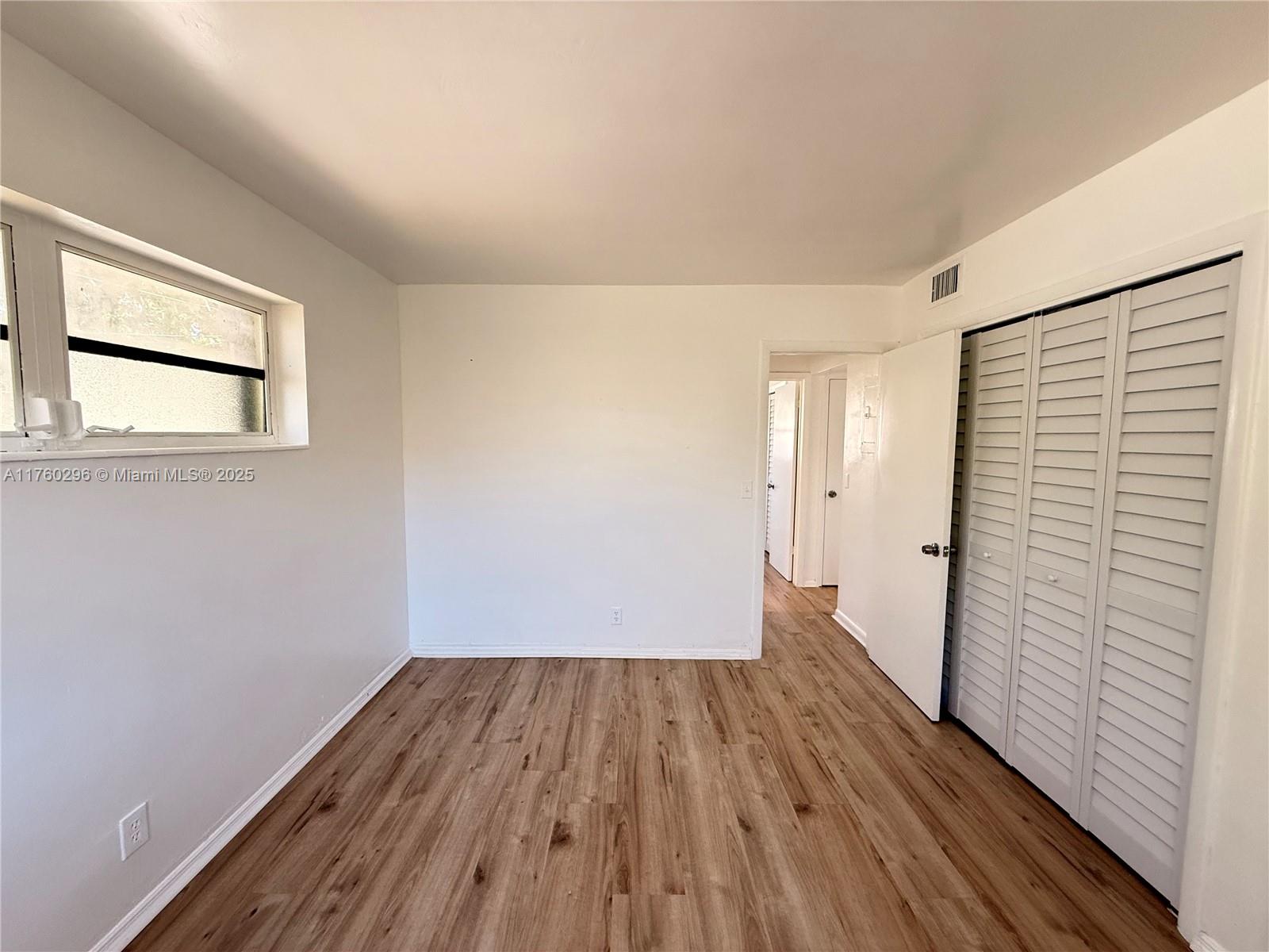 801 Southwest 7th Street, Unit B Pompano Beach, FL 33060 - Photo 16 of 20 a view of a room with wooden floor and a balcony