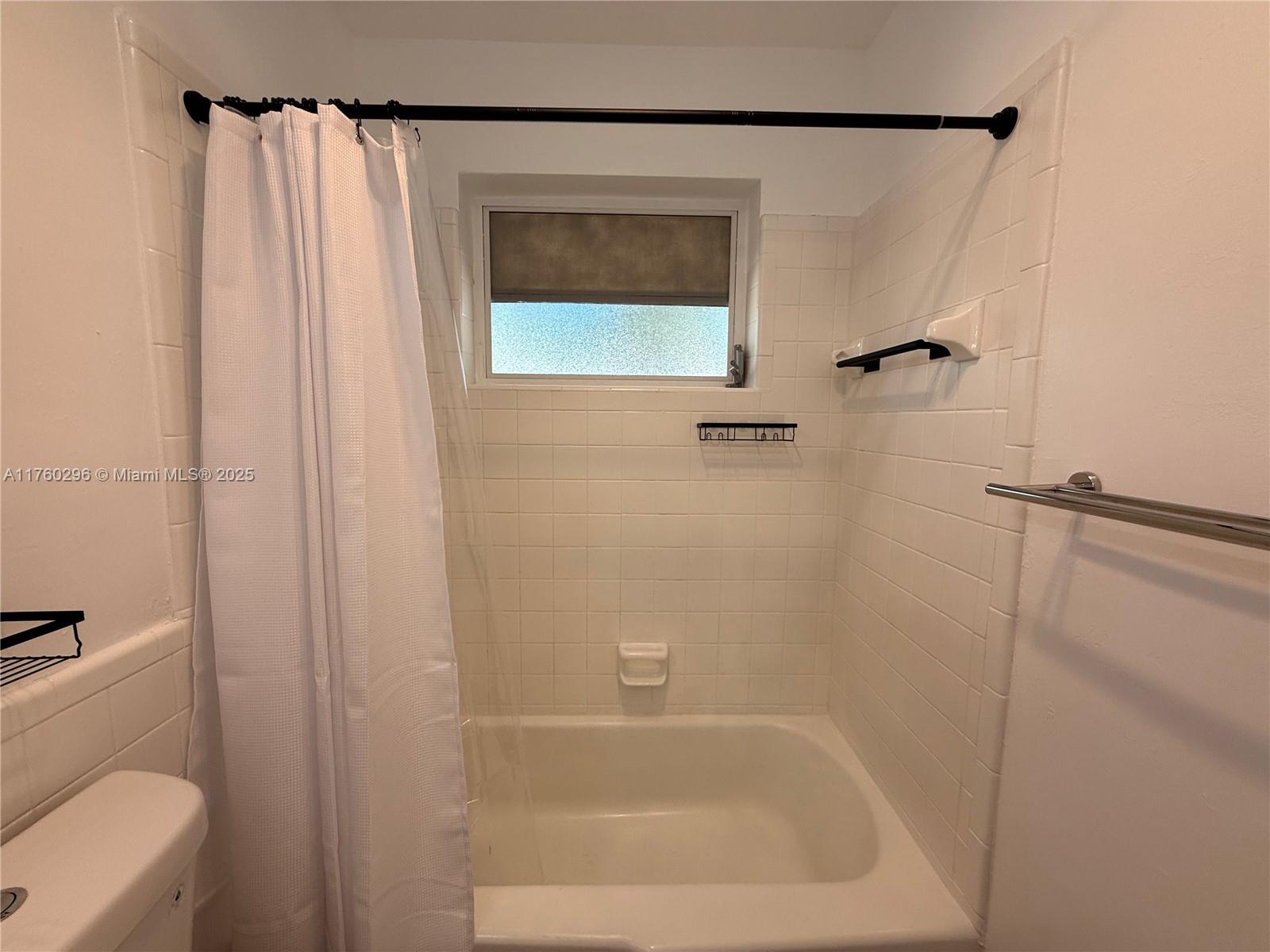 801 Southwest 7th Street, Unit B Pompano Beach, FL 33060 - Photo 18 of 20 a bathroom with a shower and a tub