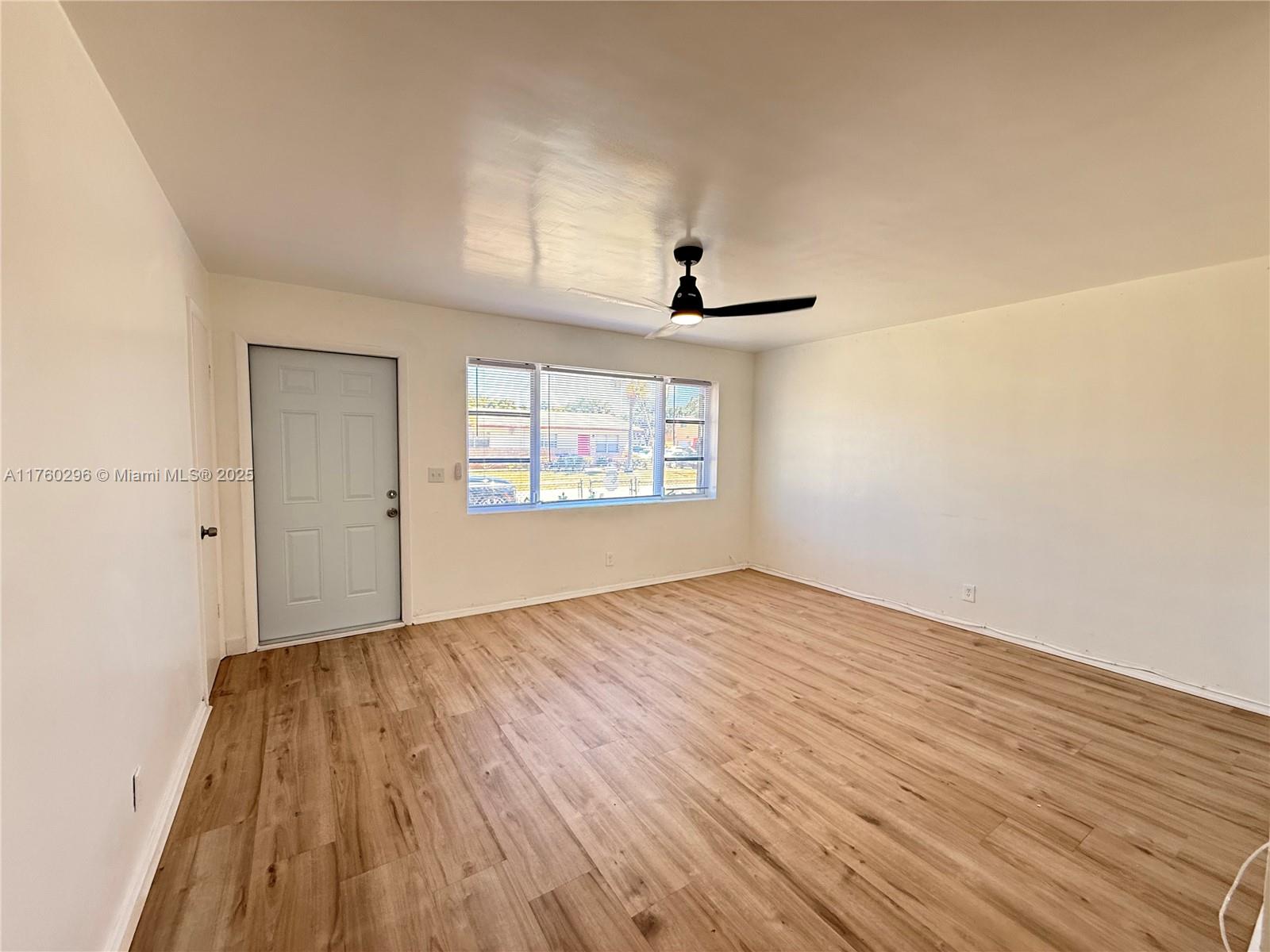 801 Southwest 7th Street, Unit B Pompano Beach, FL 33060 - Photo 5 of 20 wooden floor in an empty room with a window
