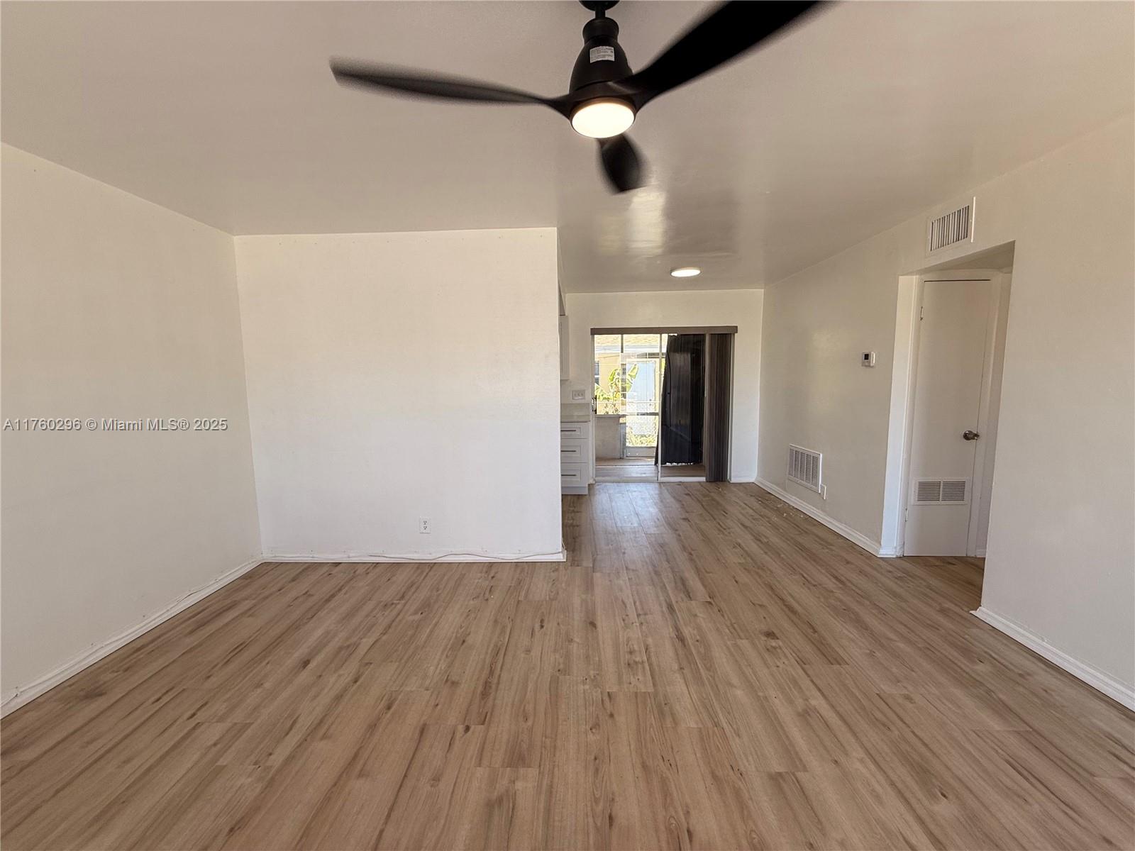 801 Southwest 7th Street, Unit B Pompano Beach, FL 33060 - Photo 7 of 20 wooden floor in an empty room with a window