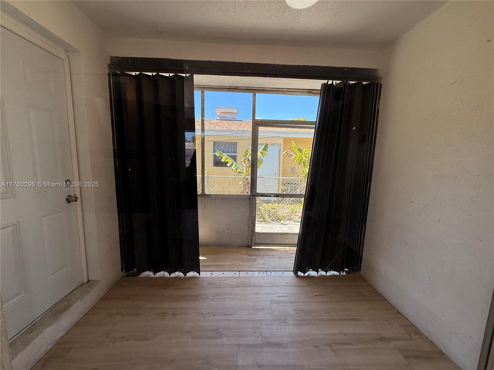 801 Southwest 7th Street, Unit B Pompano Beach, FL 33060 - Photo 9 of 20 wooden floor in an empty room with a window